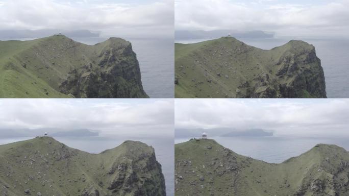 无人机飞越位于丹麦法罗群岛上的卡尔索伊岛 (Kalsoy Island) 上绿色崎cliff的悬崖山