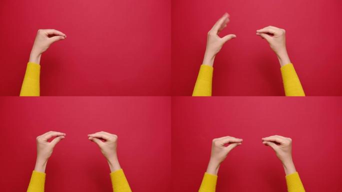 女性的特写镜头显示彼此交谈，双手隔离在红色工作室背景下，带有复制空间。肢体语言概念。有文字或图片、宣