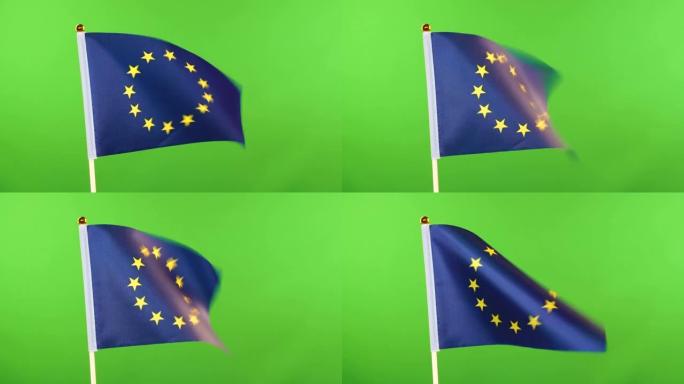 绿色背景旗杆上的欧盟旗帜。欧盟旗帜迎风飘扬。