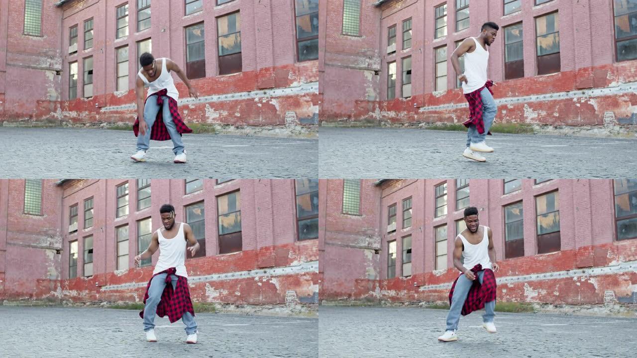 年轻的黑人在街上跳舞。他有时髦的发型和绑在腰间的衣服。