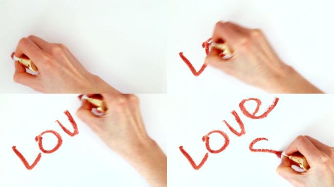 女孩在白色背景上用红色唇膏书写爱情，这是情人节的心脏象征
