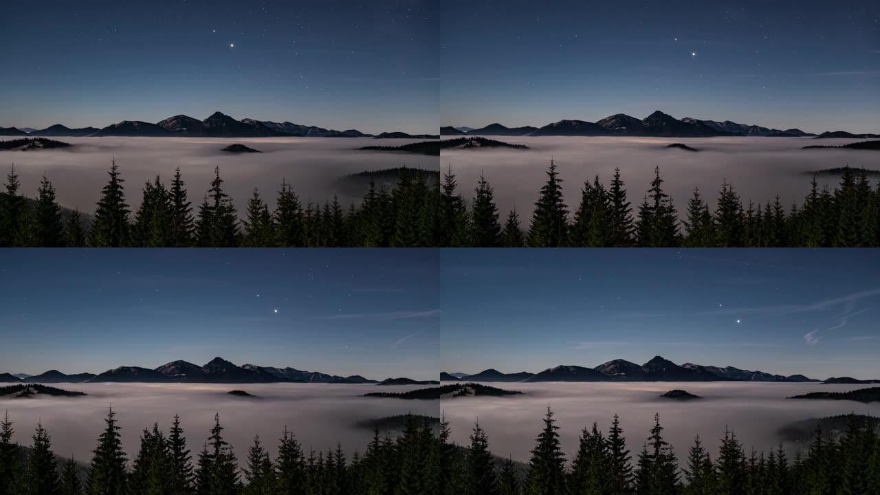 蓝色天空，高山山脉，森林和雾云上方的星星在月光下的夜晚快速运动自然景观时间流逝