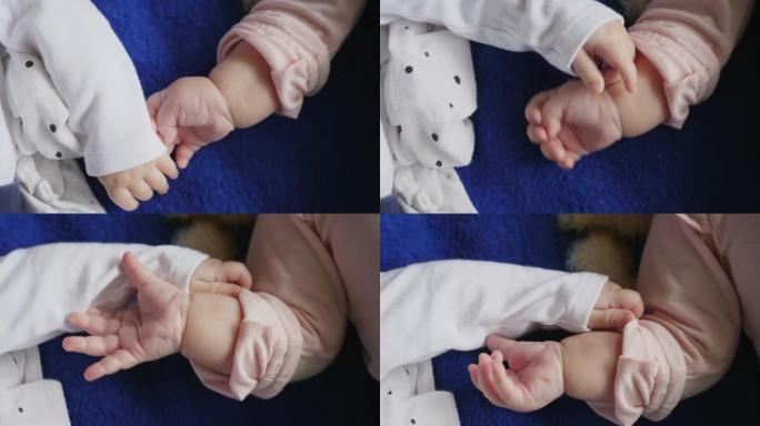 婴儿的手互相触摸，两个婴儿在一起