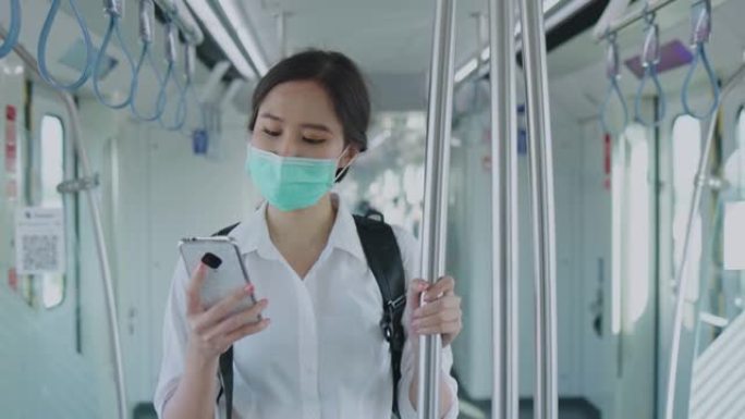 亚洲女商人戴上医用口罩，防止冠状病毒和PM2.5粉尘。乘坐火车和公共交通工具旅行，与社会距离保持距离