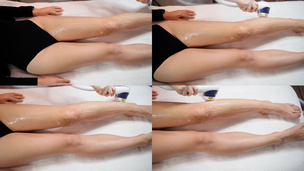 认不出来的人。女美容师做激光脱毛苗条的腿上的女人是躺在一个美容沙龙的医疗沙发上。宇宙学，脱毛和水疗概