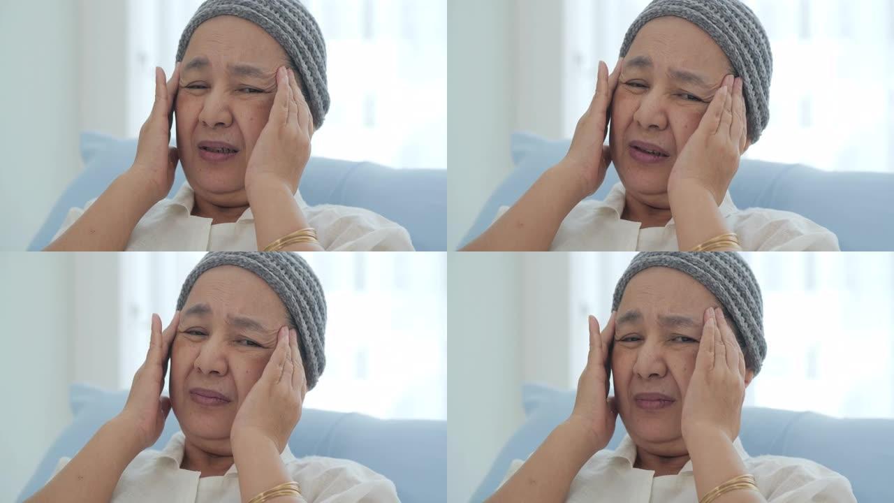 一位戴着头巾的癌症老妇人躺在医院的病床上，她头疼不已。