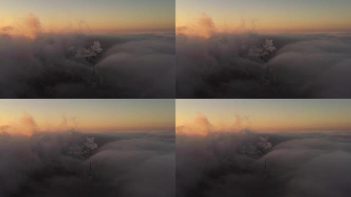在日落时，空中无人机透过工业管道上的云层