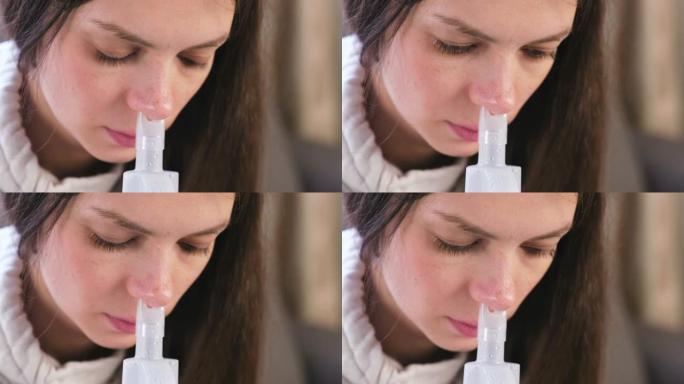 使用雾化器和吸入器进行治疗。年轻女子通过鼻子的吸入器喷嘴吸气。特写脸。