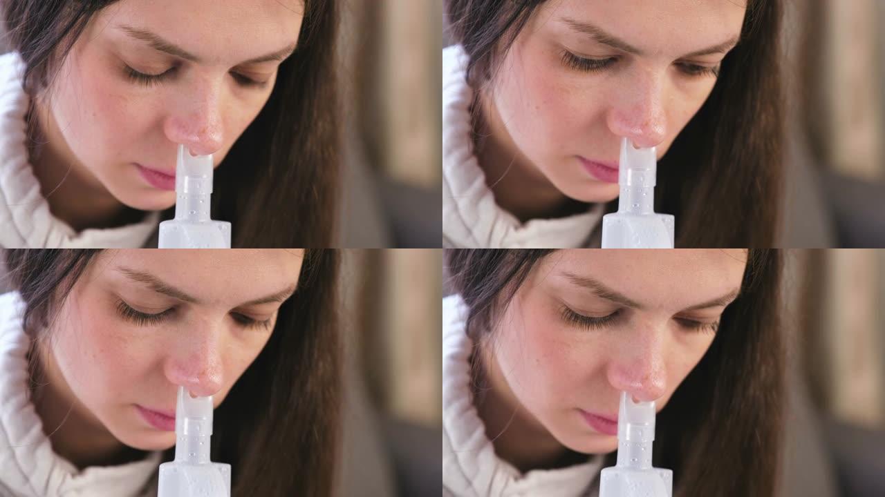 使用雾化器和吸入器进行治疗。年轻女子通过鼻子的吸入器喷嘴吸气。特写脸。