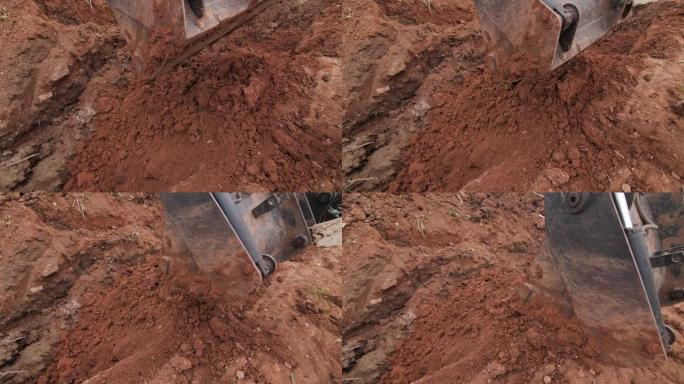 挖掘机桶在施工现场的埋孔上移动