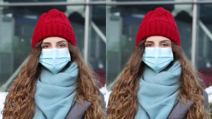 站在街上的医用口罩上的年轻卷发女性肖像的垂直镜头。大流行性流感电晕病毒。疫情冠状病毒。人群患病新型冠