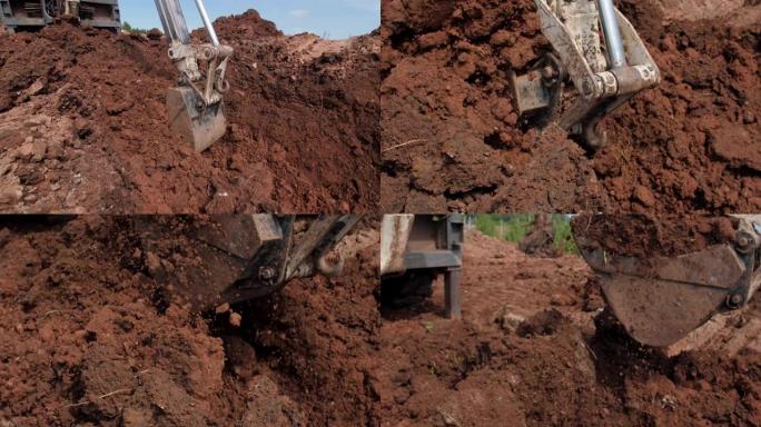 挖掘机在露天施工现场用桶取出土壤