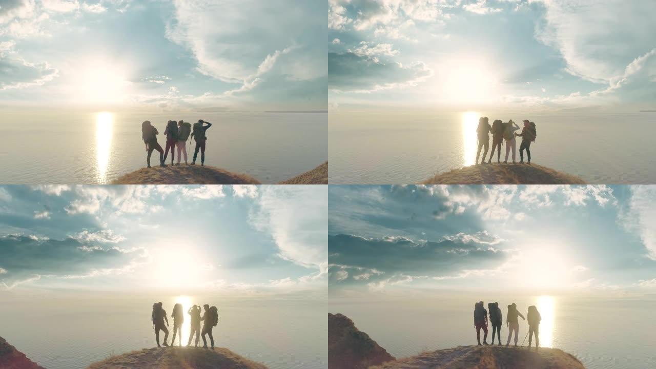 在美丽的背景下，四个人站在山崖上