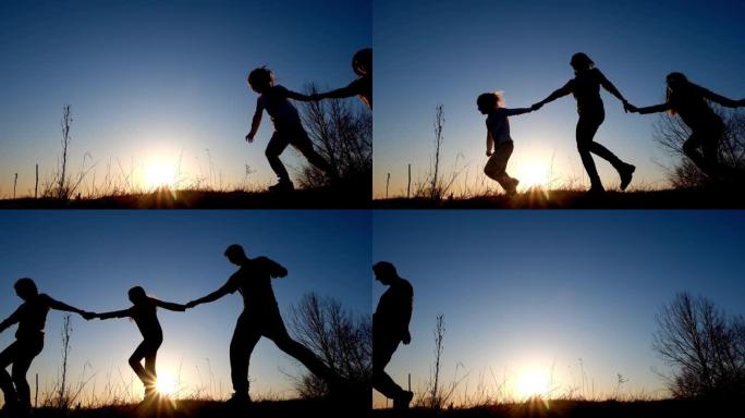 母亲，父亲和女儿在日落时奔跑和娱乐的剪影
