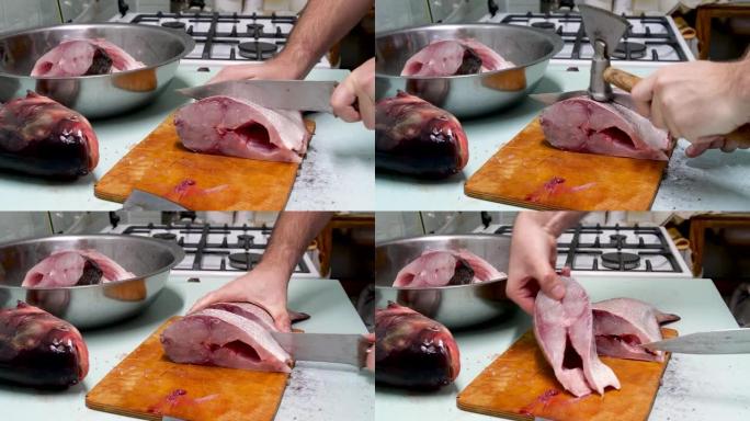 男人准备新鲜的silver鱼。用刀把它切成牛排。家庭烹饪概念