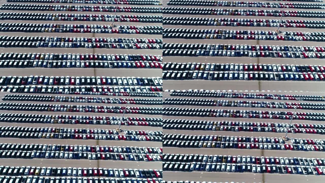 鸟瞰图，无人机在白天停在停车场的彩色汽车上方。西班牙4k停车场的无人机美景