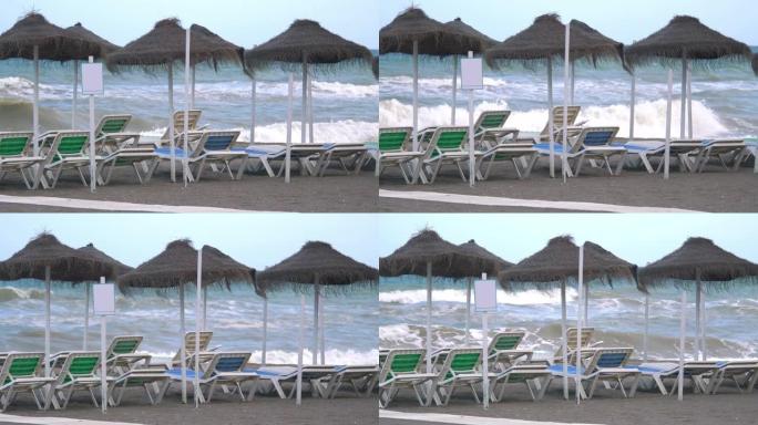 在4k慢动作60fps的大流行期间，空旷的封闭海滩上的海滩日光浴床