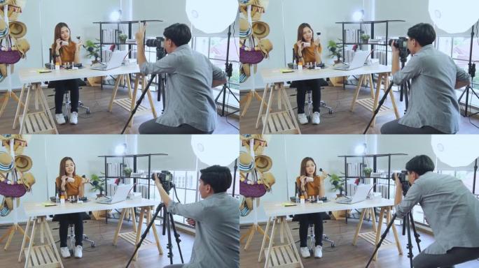 年轻的亚洲夫妇博主录制vlog视频，有影响力的人在工作室用化妆化妆品在社交媒体上直播，在线学习教程