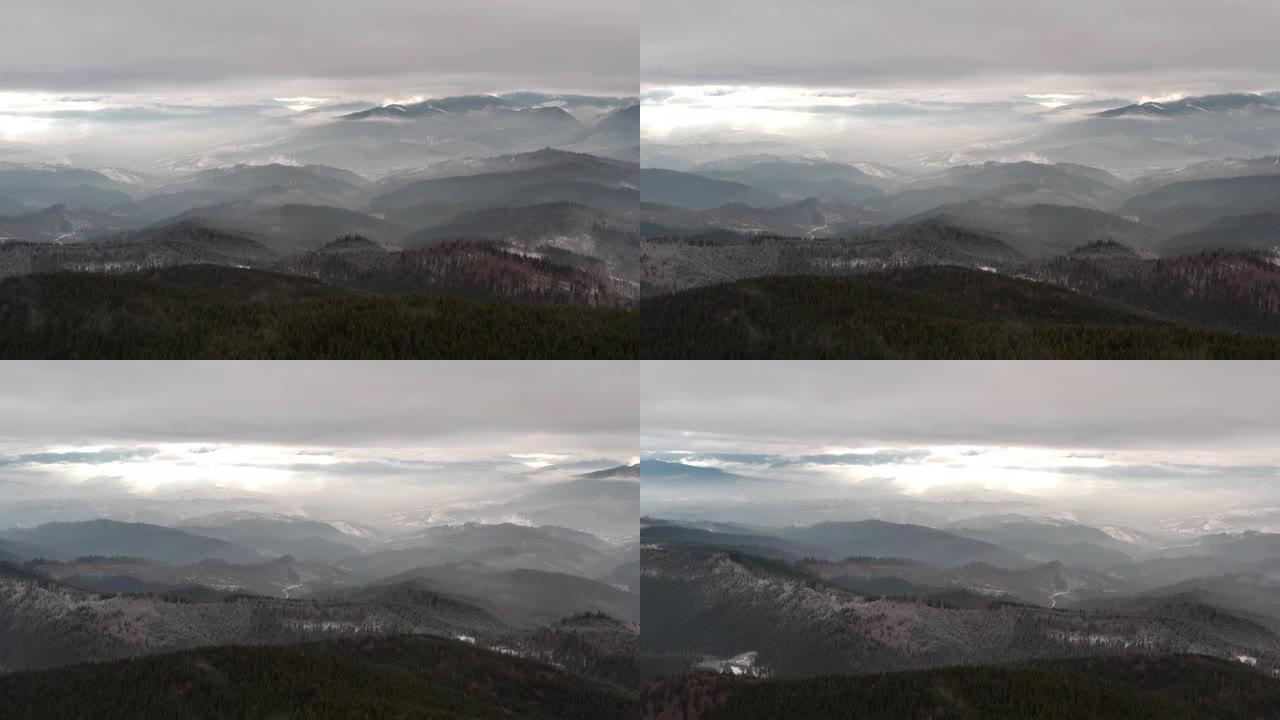 鸟瞰图。阴天秋日神秘的山景。高地的雾森林。自然背景。喀尔巴阡山脉。多云灰色的冬季景观
