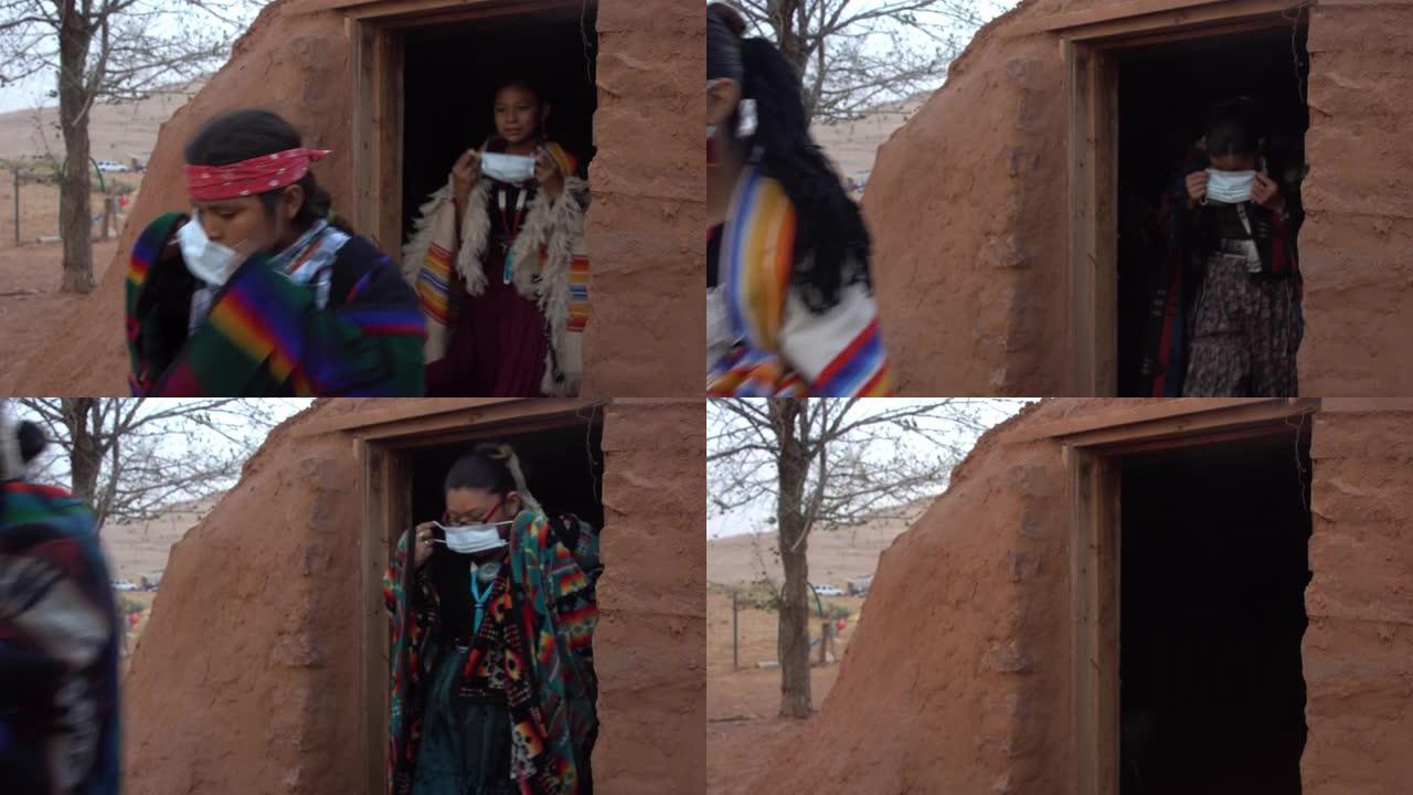 年轻的纳瓦霍人一家人戴着口罩走出霍根，以帮助防止新型冠状病毒肺炎