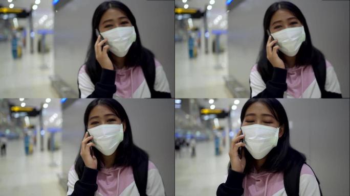 亚洲妇女在机场航站楼主厅戴防护口罩电话，转机旅客询问信息呼叫中心，病毒新型冠状病毒肺炎大流行，新常态