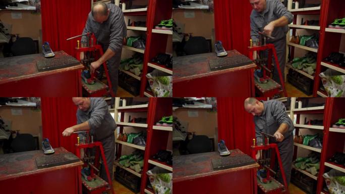 专用的男性鞋匠在运动鞋修理时使用手动压力机