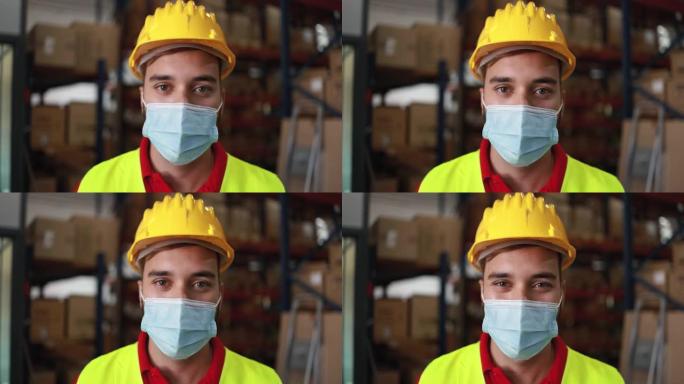 冠状病毒爆发期间，在送货箱仓库内戴着防护口罩的工人
