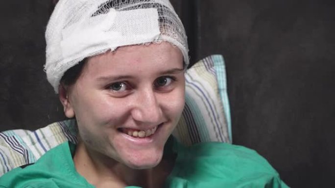 头部受伤的女孩在绷带治疗后微笑