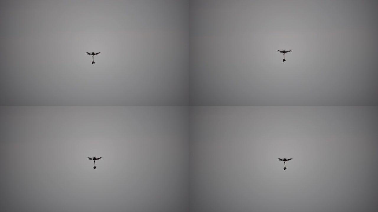 专业摄影无人机直升机的轮廓，全景摄像机在空中飞行。海上日落的空中全景。日落时的车辆和复印空间