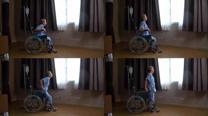 资深女性患者独自坐在轮椅上，望着窗外，试图站起来，直到在医院病房取得成功。孤独的老年女性在康复疗养院