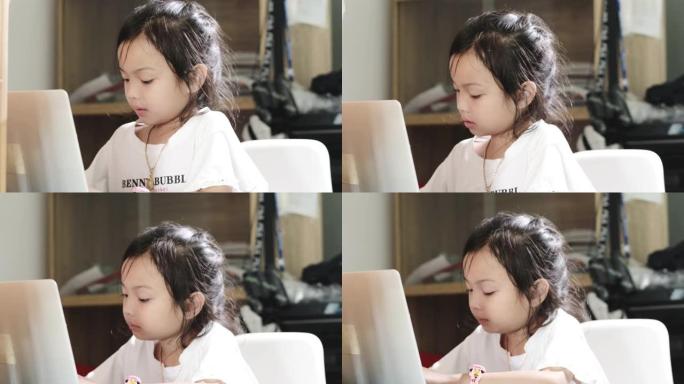 亚洲女孩在家使用笔记本电脑时打喷嚏，家庭教育理念。