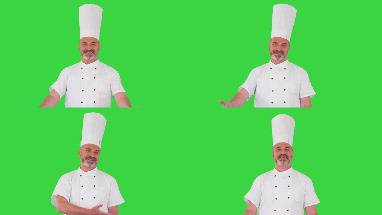 专业厨师在绿色屏幕上向相机发出欢迎手势，色度键