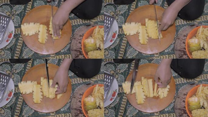 用锋利的刀在大砧板上切菠萝