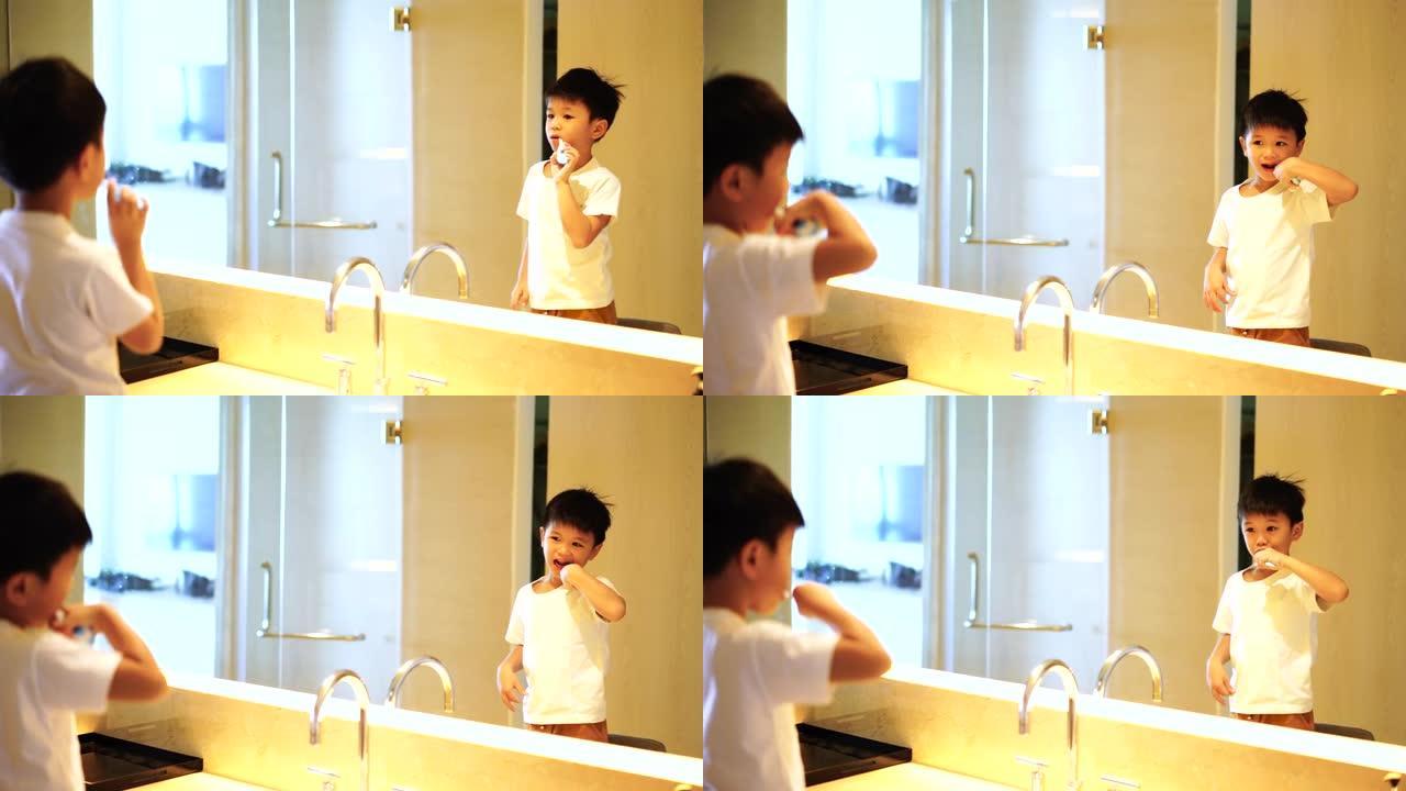 亚洲孩子在浴室刷牙。日常健康和牙科护理的概念