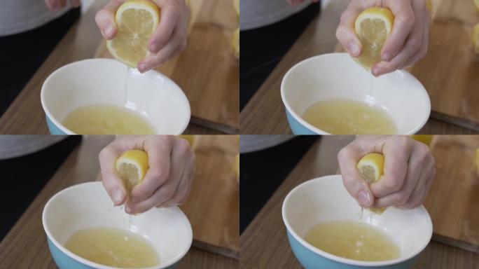 慢动作镜头是在厨房柜台上的碗里挤柠檬汁。