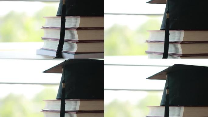 教育知识学习出国留学国际理念。教科书上的毕业庆祝帽子在图书馆堆放了大量文献，在世界范围内学习和重返学