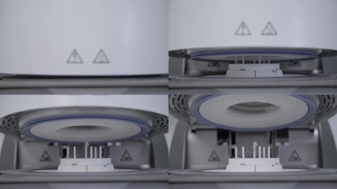 牙科诊所极高温烤箱中的人造牙齿。牙科技师在专用炉机中烘烤陶瓷牙齿。技术人员在牙科实验室中的牙齿重建过