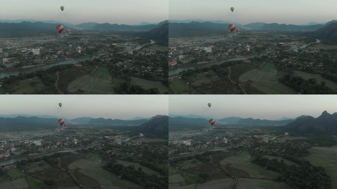 空中: 亚洲老挝的万荣背包客旅游目的地。日落时的热气球