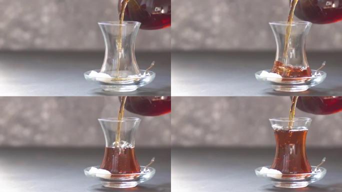从茶壶中倒出的土耳其红茶，传统的热饮，慢动作
