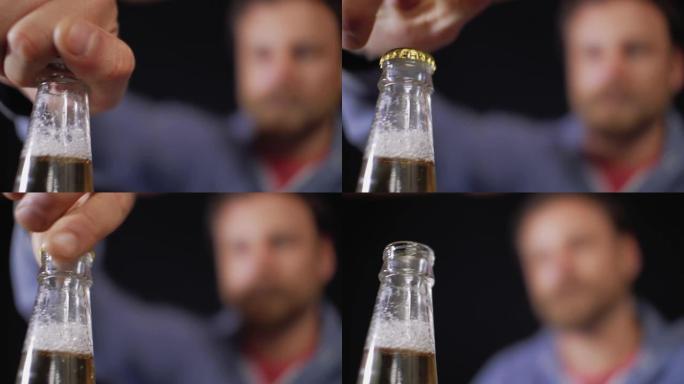 男人打开一瓶啤酒。男性手拧开一瓶啤酒的盖子。4k视频