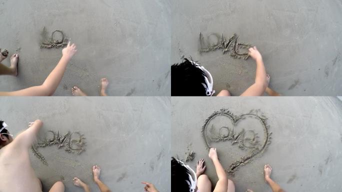 男孩在海滩上写爱情和心形，生活方式的概念。