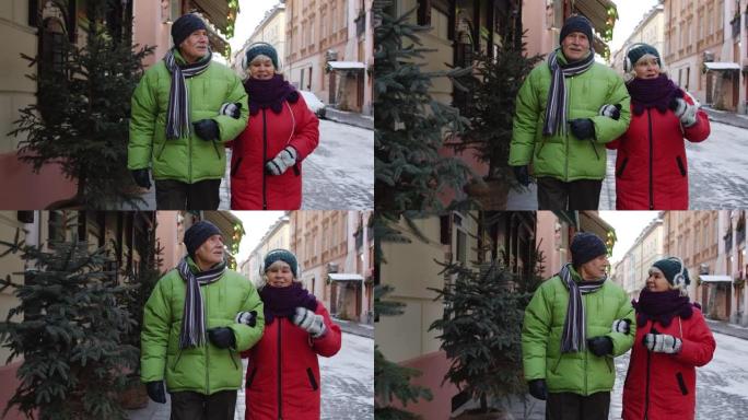 高级夫妇祖母祖父游客穿着冬季夹克服装在城市散步，说话