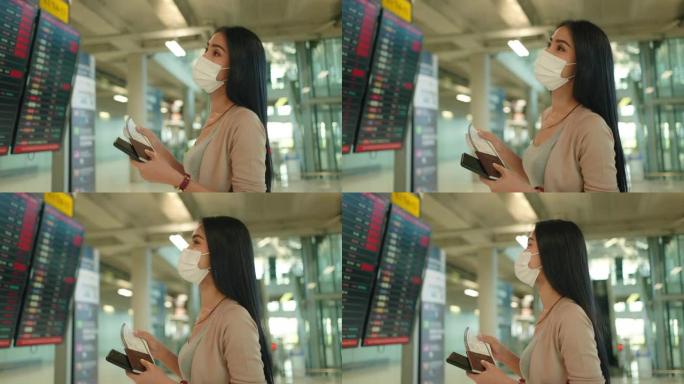 亚洲商务女性在登机处检查航班。