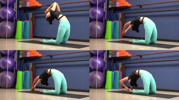 女孩通过铺板瑜伽姿势锻炼身体。瑜伽健身在工作室班，身体健康。