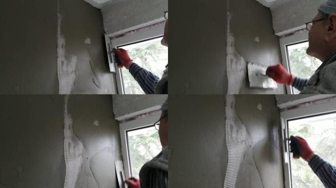 修理工用抹刀抹灰墙