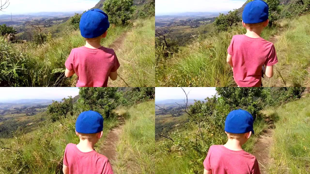一个小男孩在山上徒步旅行的慢动作