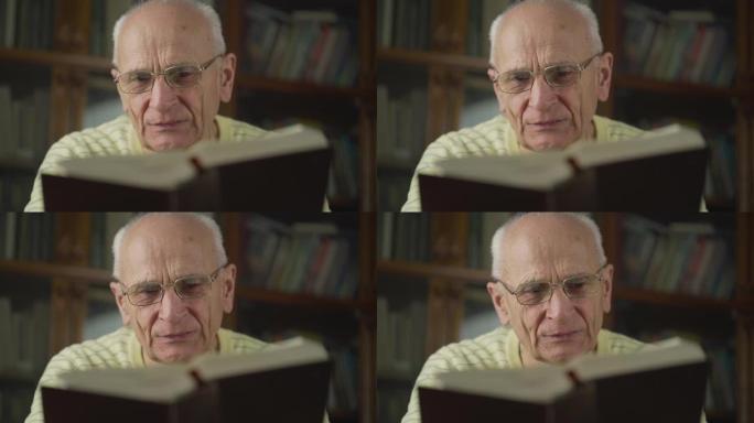 戴眼镜的老人仔细阅读书籍室内视野