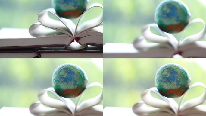 国际大学或学校学习概念的国外教育学习或知识。打开书本上的地球模型，家里桌子上有灯光耀斑。