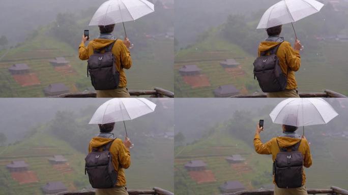 一名年轻的旅行者站在猫猫谷的手机上拍摄自拍照。南a Pa，越南北部。越南旅游概念