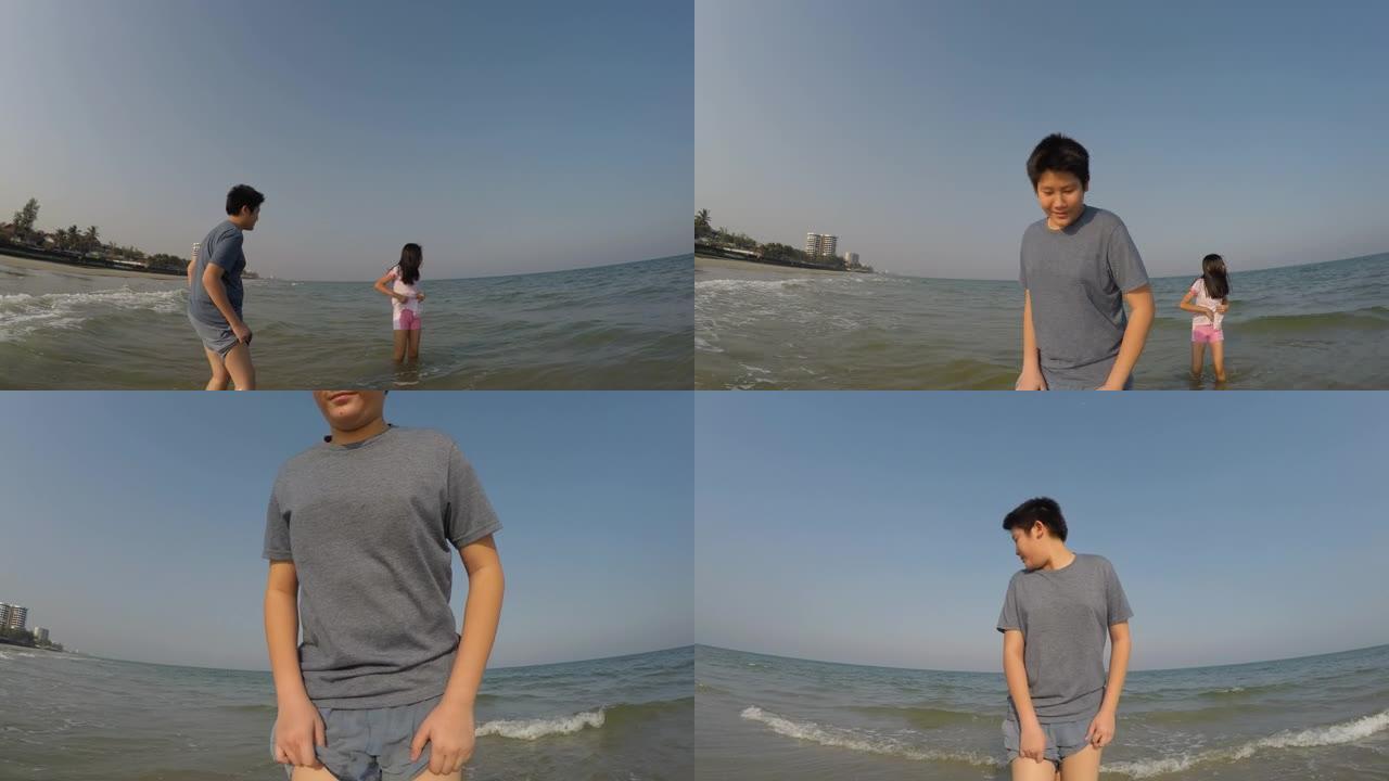 快乐的亚洲儿童一起在海滩上奔跑，同时与家人一起享受假期，生活方式理念。
